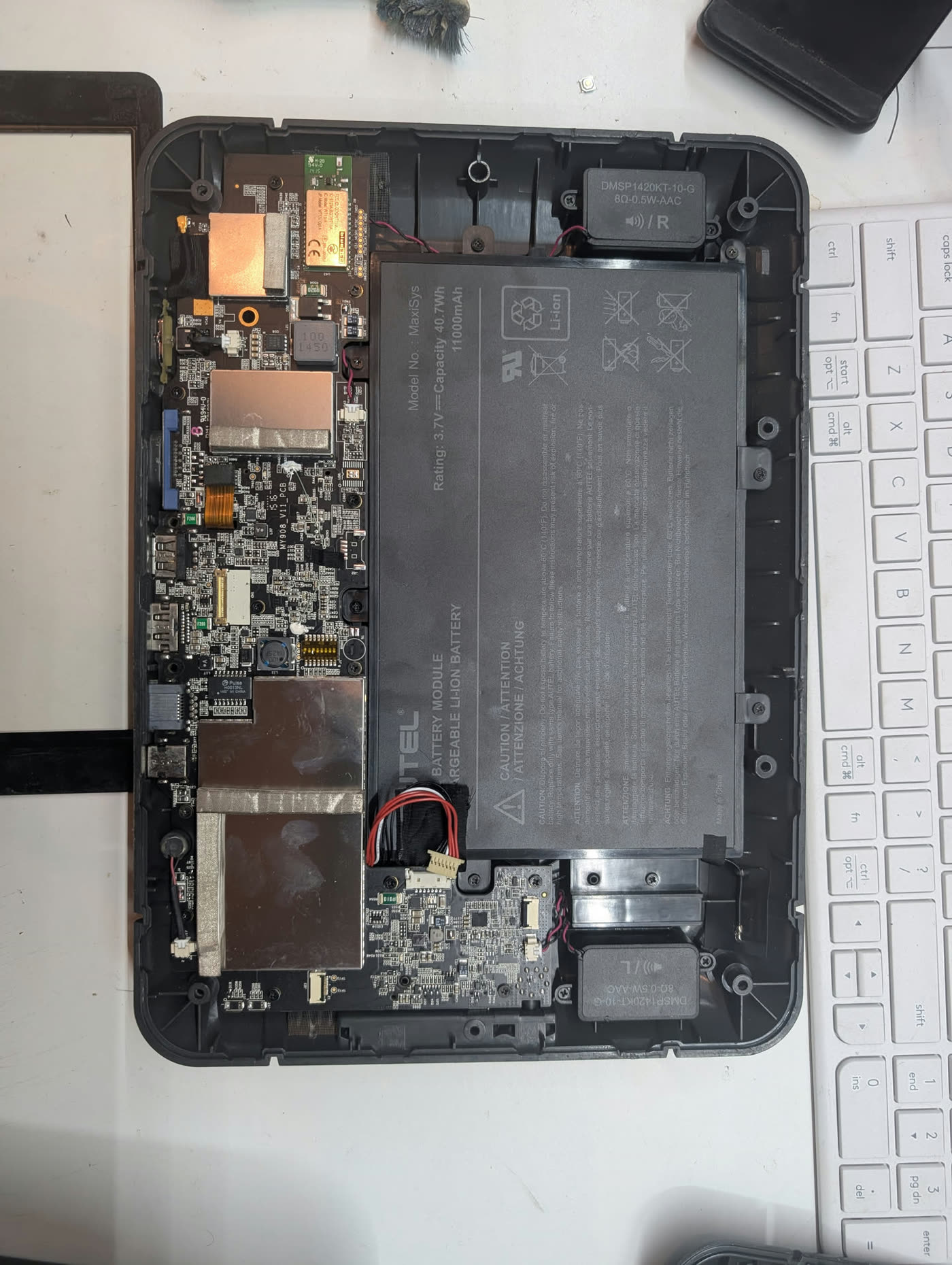 Autel MaxiSys MY908 opened with the internal mainboard and battery visible