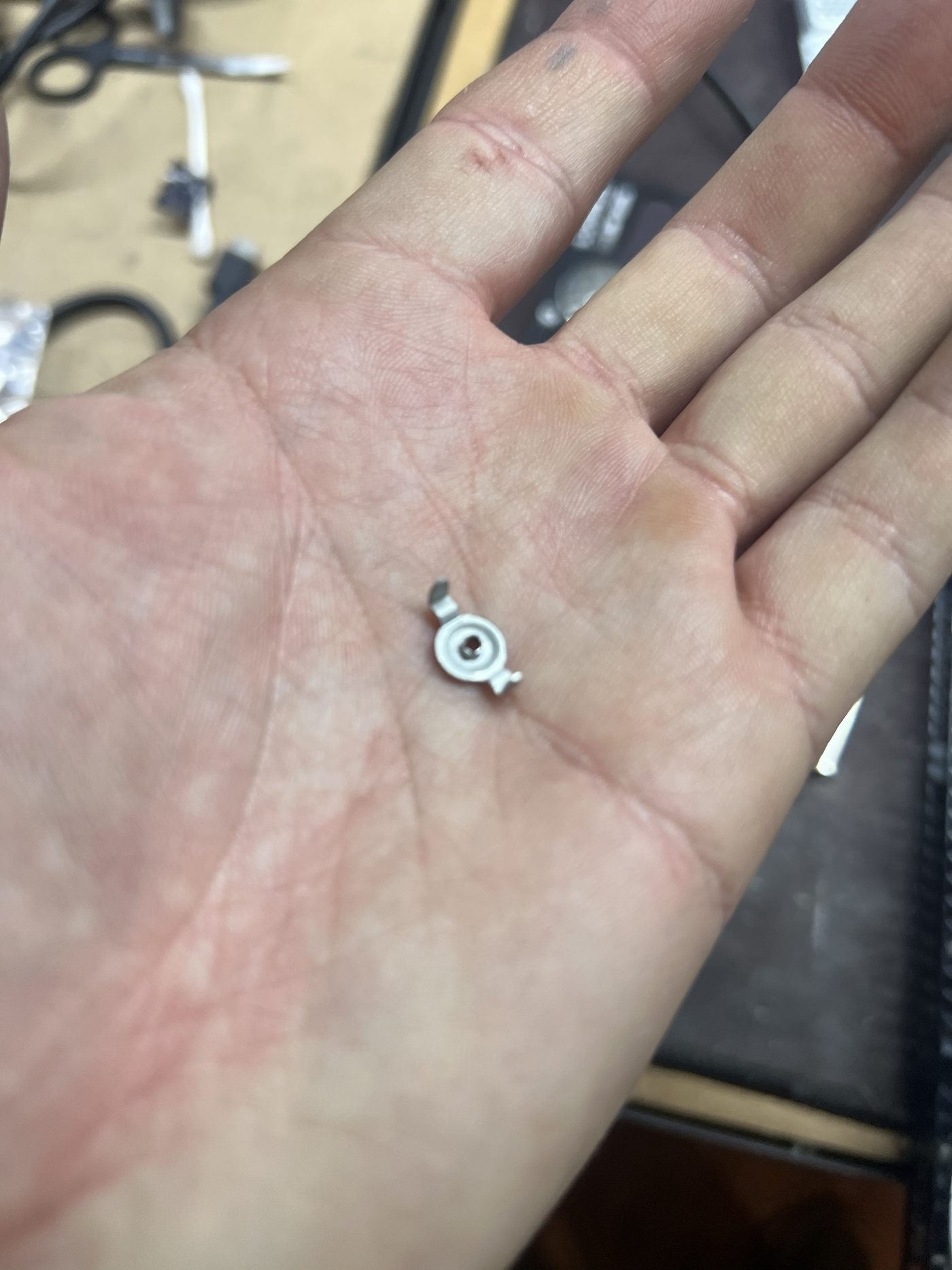 Small plastic and metal PS4 Slim heatsink assembly part in hand