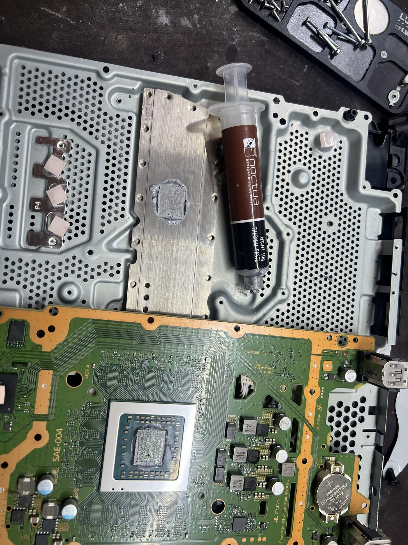 Fresh thermal paste on PS4 Slim APU during service