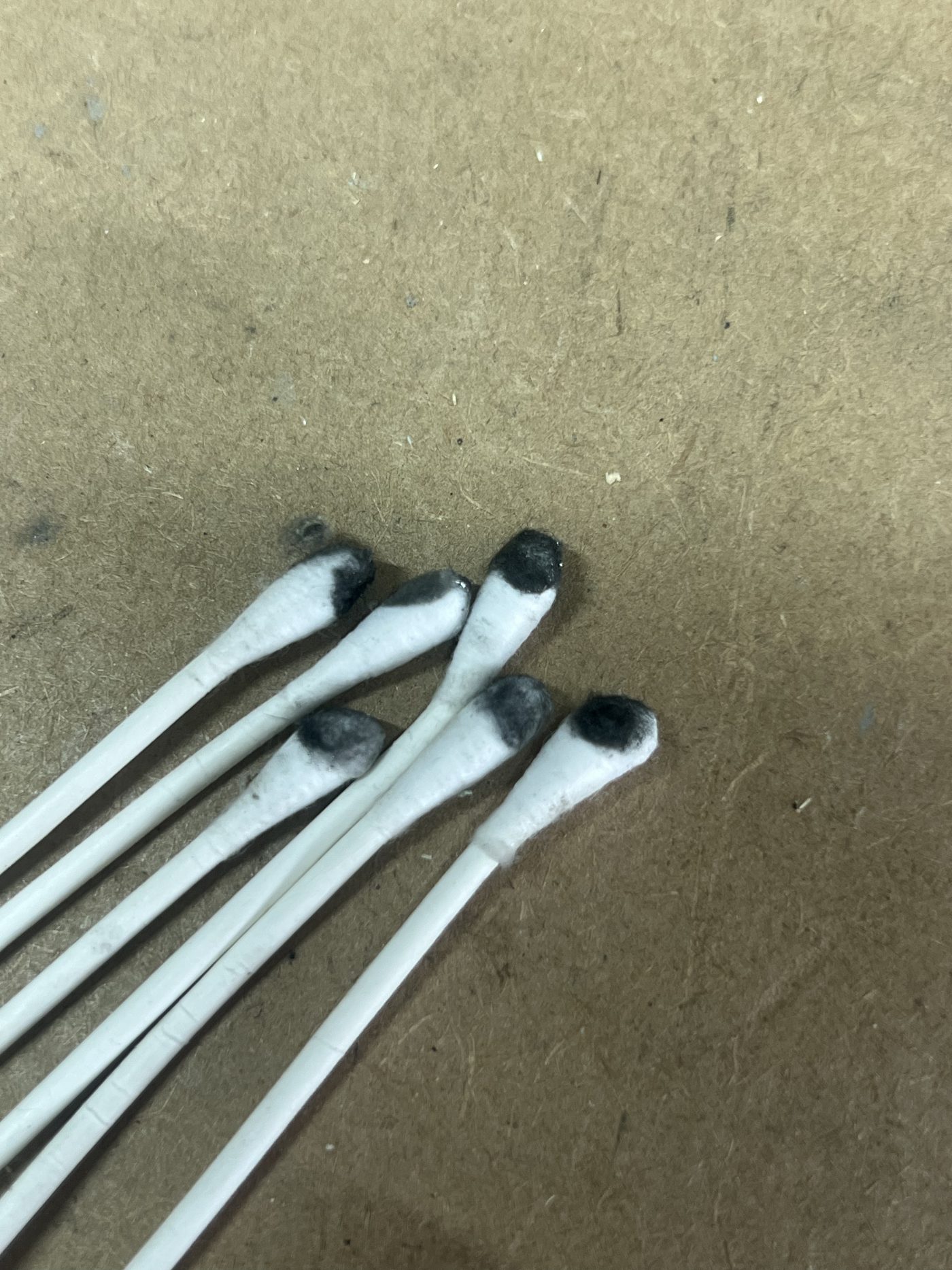 Dirty Q-tips after cleaning the PS5 Slim APU liquid metal area
